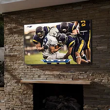 Outdoor TV mounted above fireplace