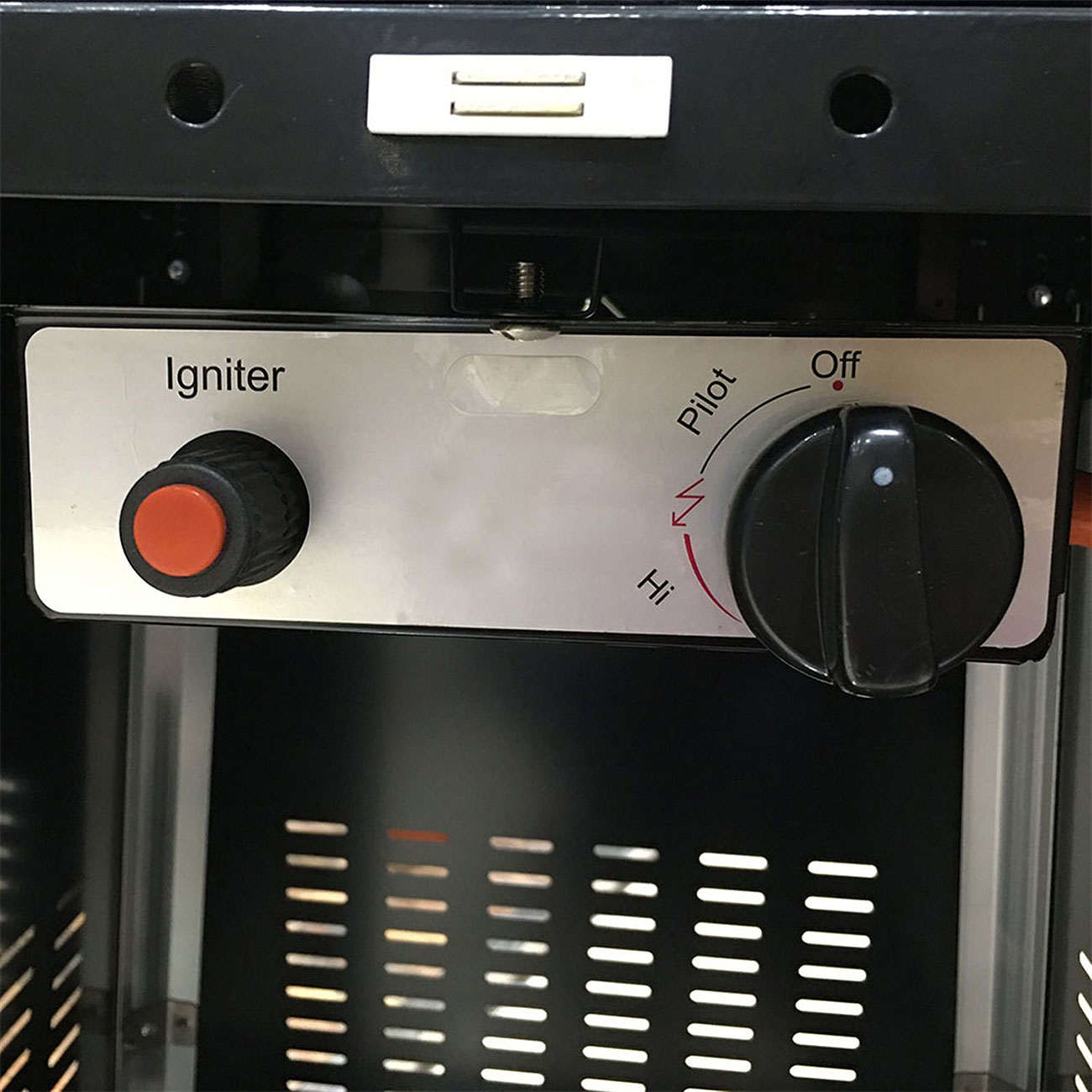 Close view of igniter button and control knob