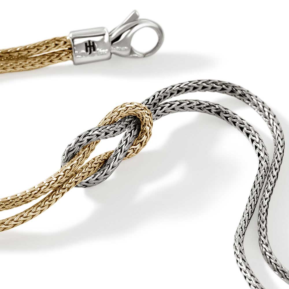 Close up view of silver and gold knot chain bracelet