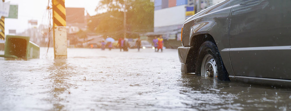Car Driving Through Flooded Street