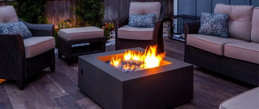 A fire table surrounded by comfortable outdoor chairs