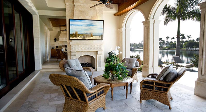 Outdoor TV in partial shade on patio wall