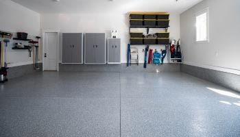 Wide shot of an organized garage door highlighting the custom flooring