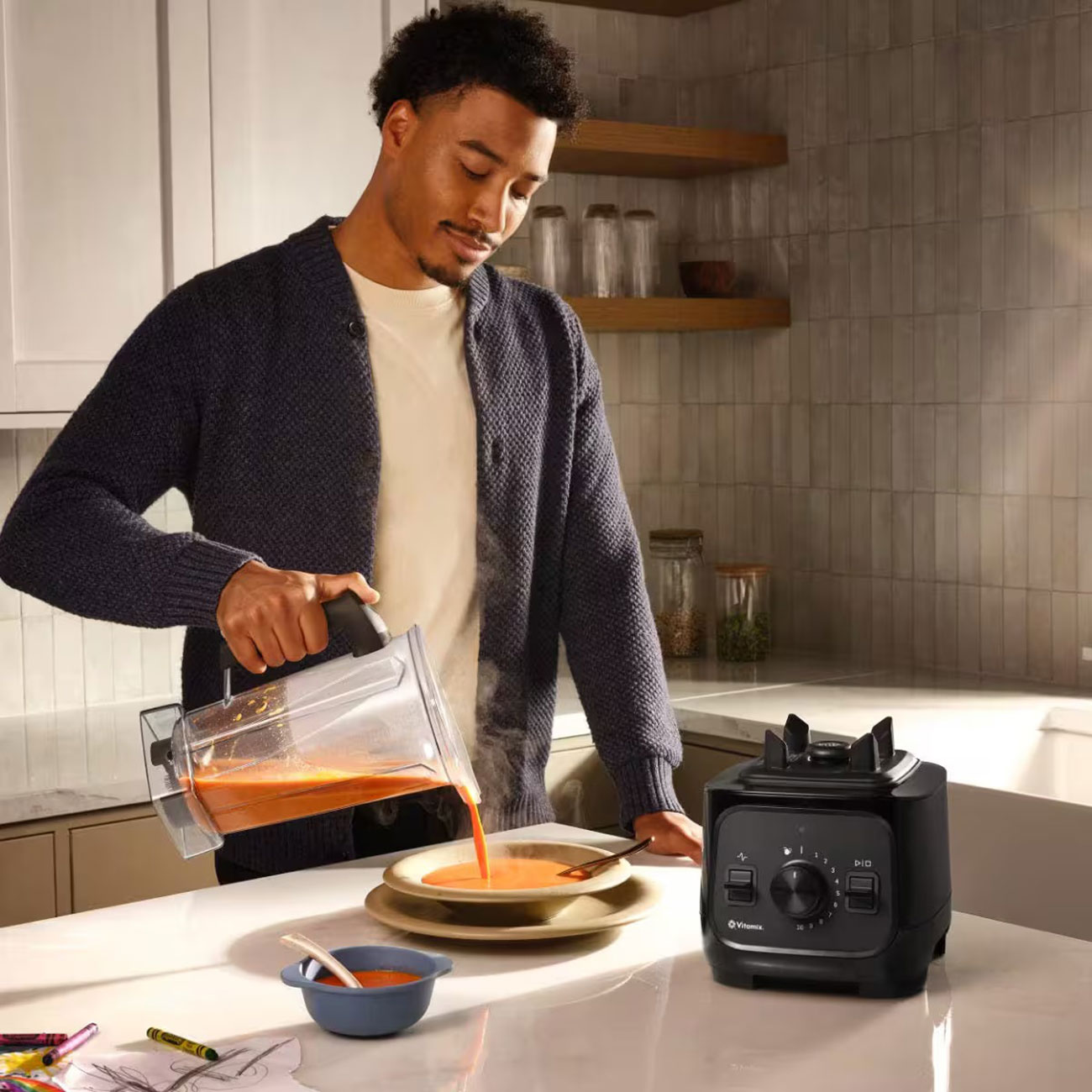 View of someone pouring soup from Vitamix VX1 Blender