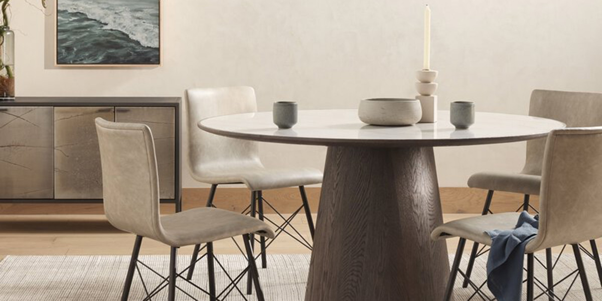 round wood dining table with tan leather dining chairs