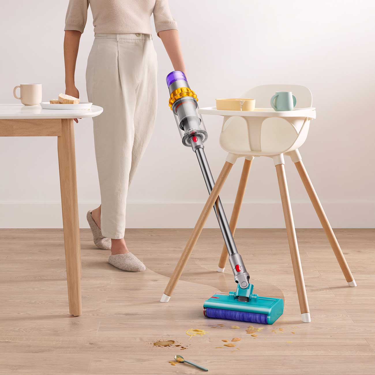 Model Using Stick Vacuum to Clean Mess Detail