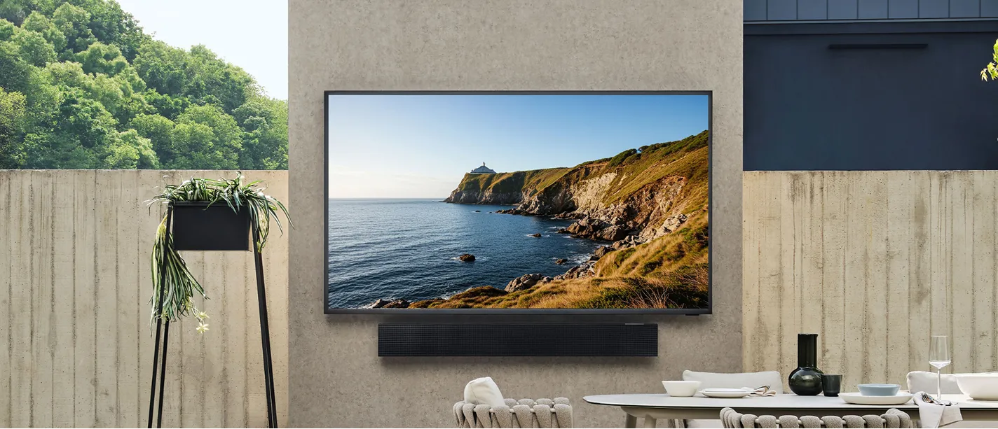 Outdoor TV mounted above a patio fireplace