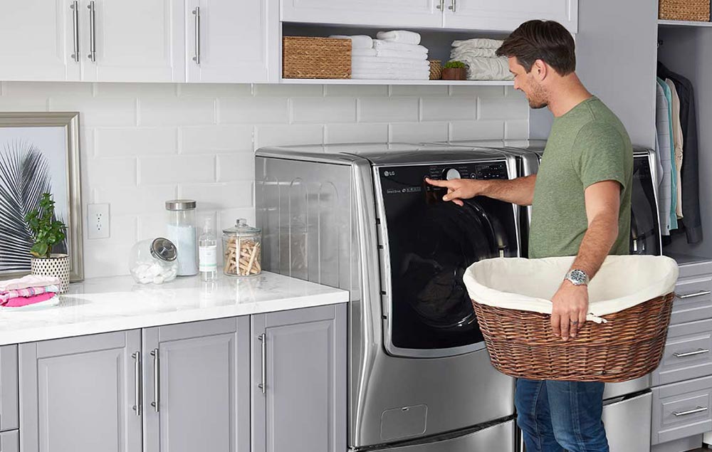 Person with laundry basket near dryer