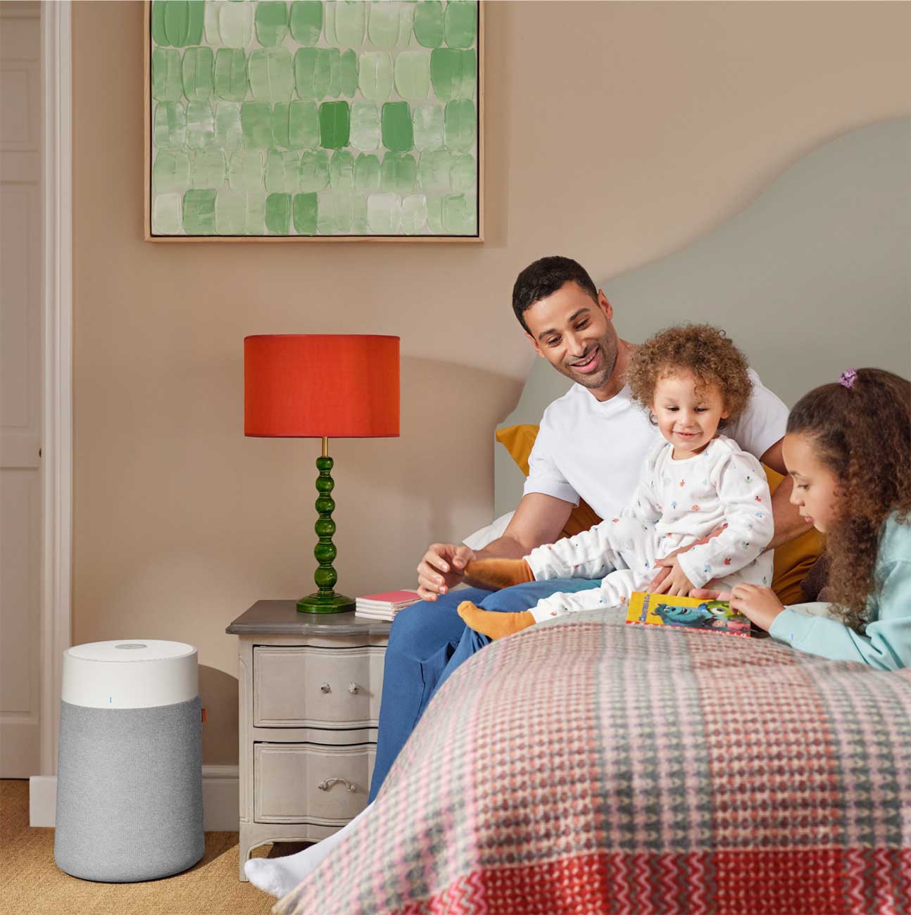 A Family Prepping For Bedtime in a Bedroom with a Blueair Air Purifier
