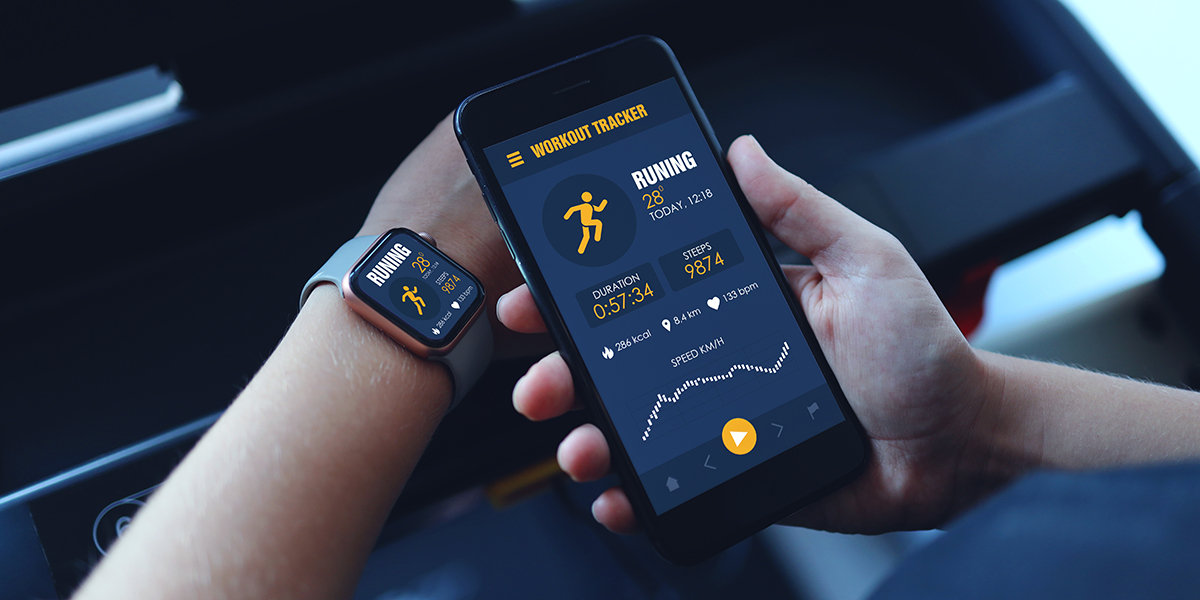 A person looking at their exercise statistics on their smartwatch and their smartphone