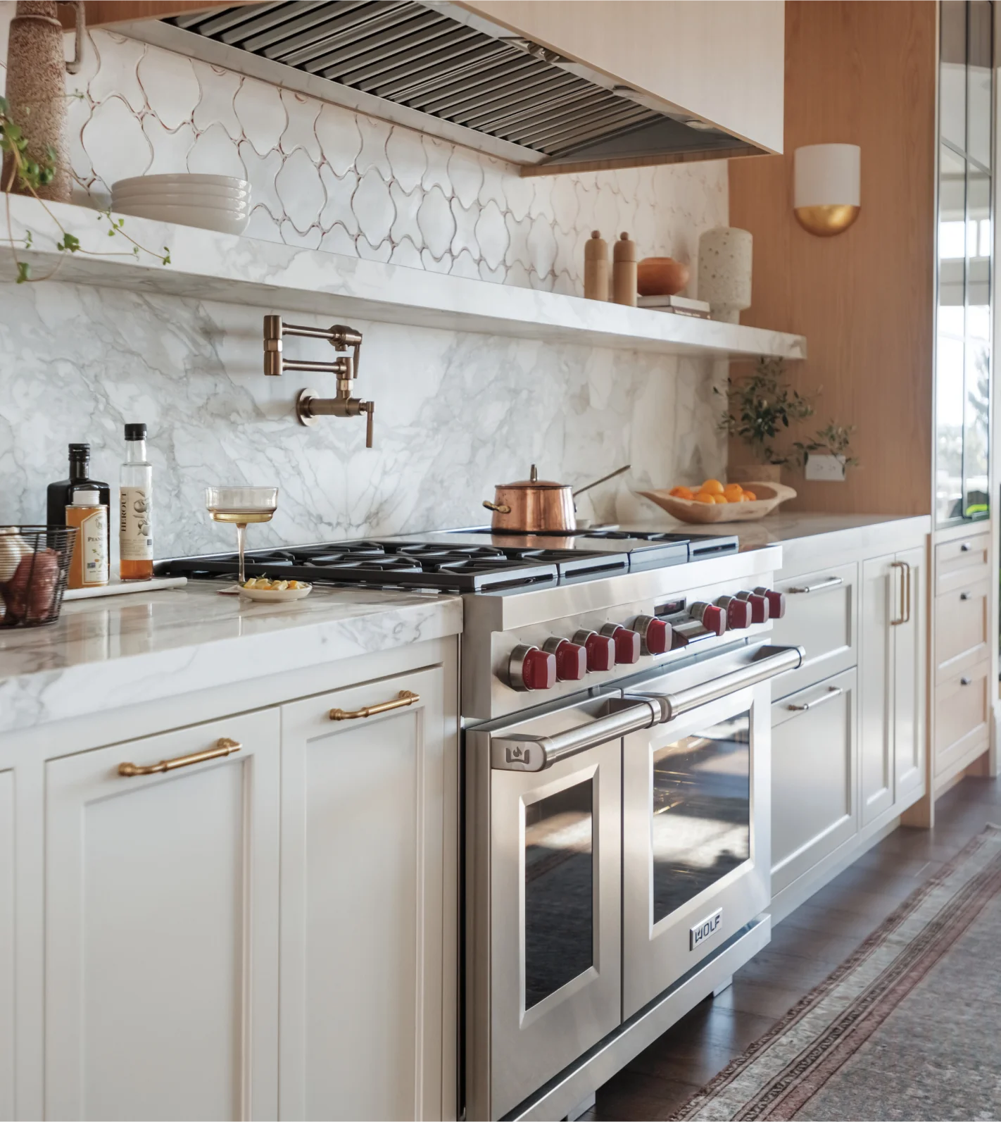 A stylish kitchen equipped with a Wolf Range stove and oven, highlighting contemporary appliances and a functional layout