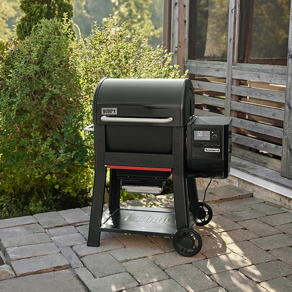 The Weber Searwood 600 sitting on a stone patio outside