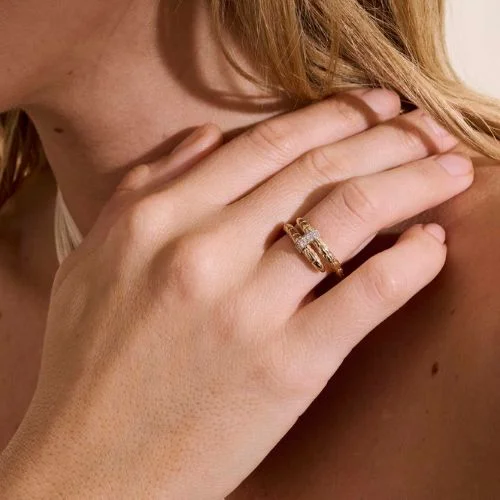 A tight shot on a persons hand wearing a John Hardy Ring