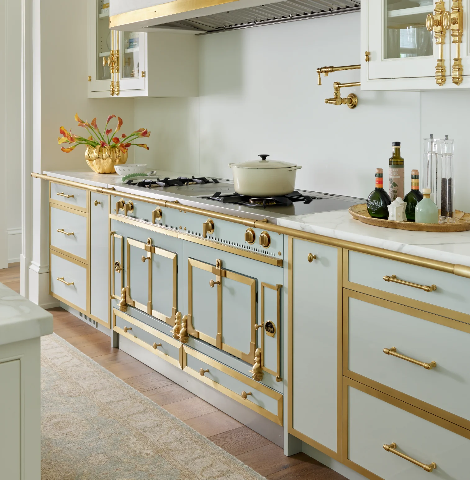 La Cornue Château kitchen with brass range, marble countertop and pot filler