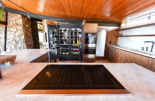 View of a range with open refrigerator in the background