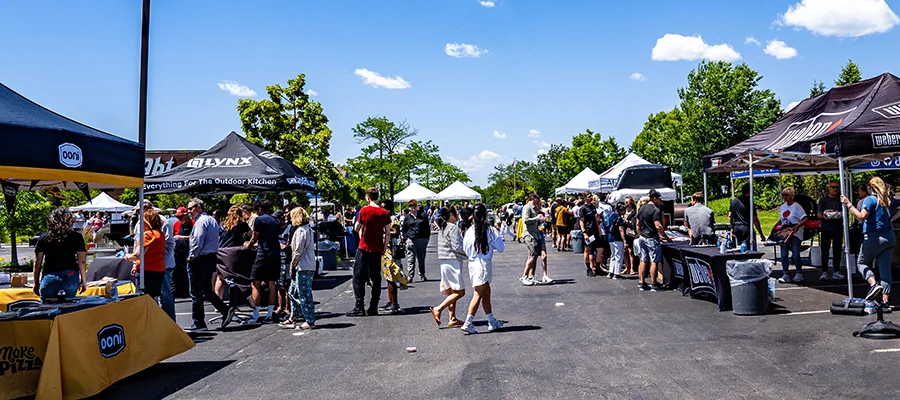 A variety of grill brand tents set up in the Abt parking lot while customers walk around and explore