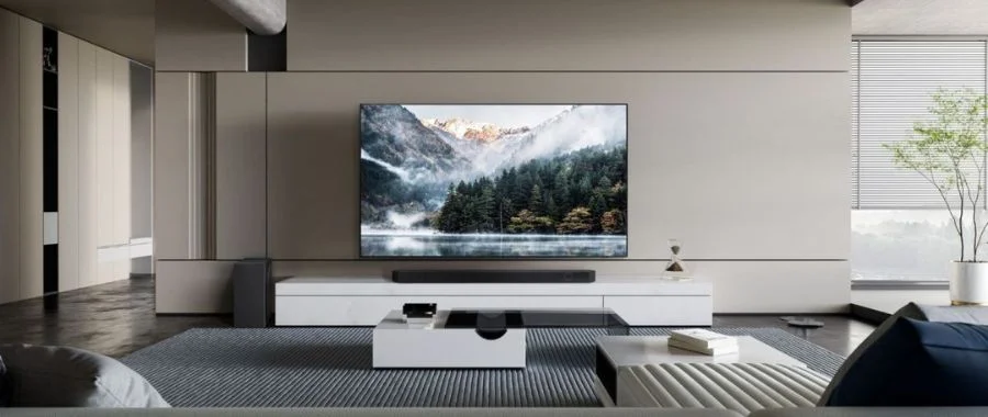 The Samsung S95D installed on a wall in a gray living room