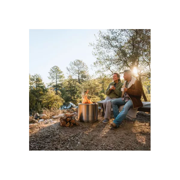 Couple Sitting by the Solo Stove Bonfire in the Woods