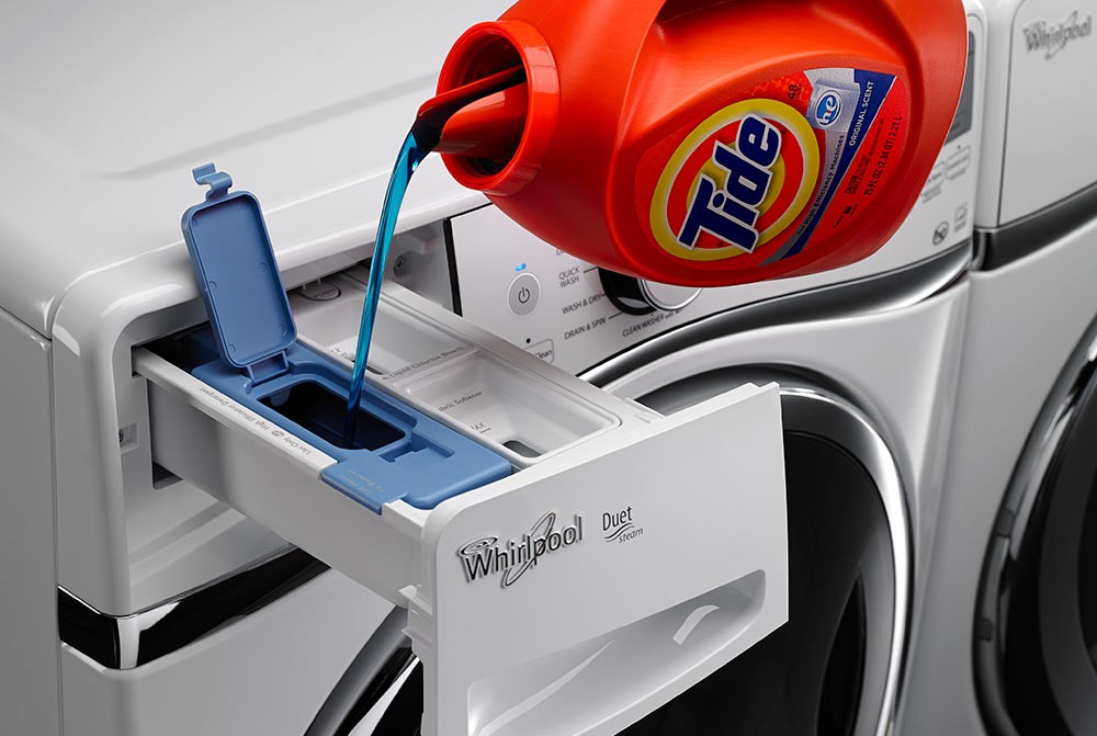 Washing detergent pouring into automatic laundry dispenser