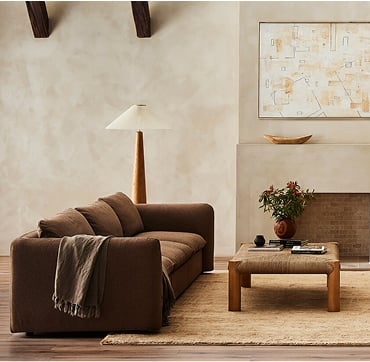 A welcoming living room showcasing a couch, a coffee table, a fireplace, and a plush rug beneath