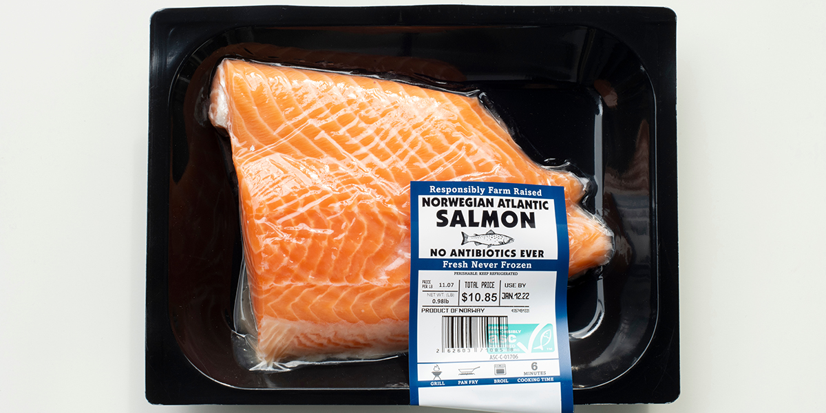 A piece of packaged Norwegian Atlantic salmon with a price and expiration date label on it
