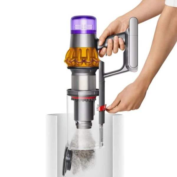 Person emptying a Dyson V15 cordless vacuum into a bin.