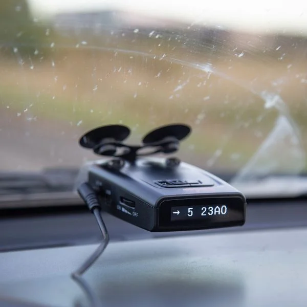 A radar detector attached to a car's windshield