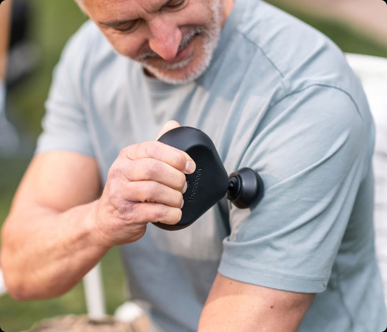 View of Therabody Theragun Mini Being Used by a Man