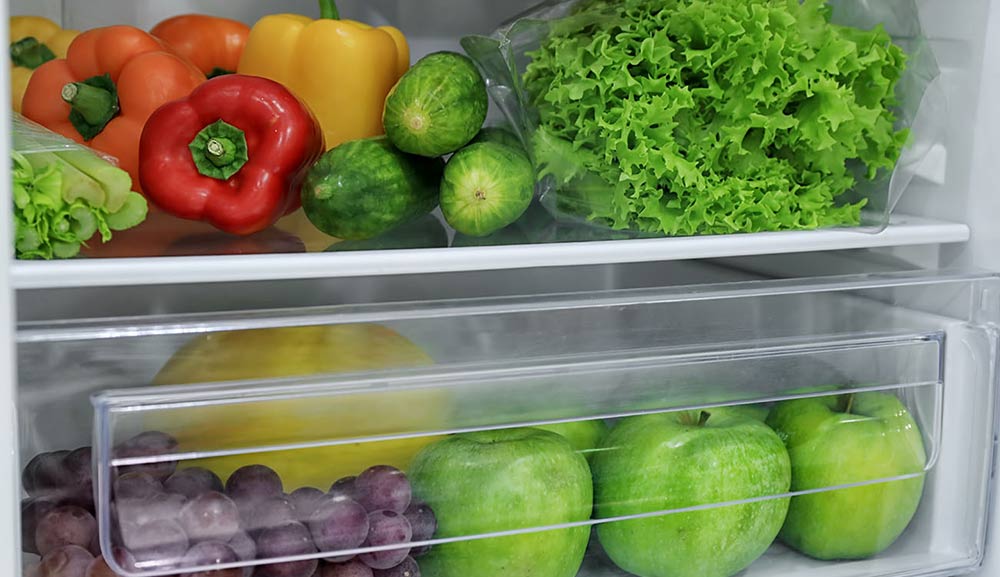 Organized Refrigerator Shevles with fresh fruit and vegetables