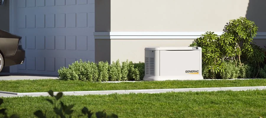 A Generac generator outside a sunny home
