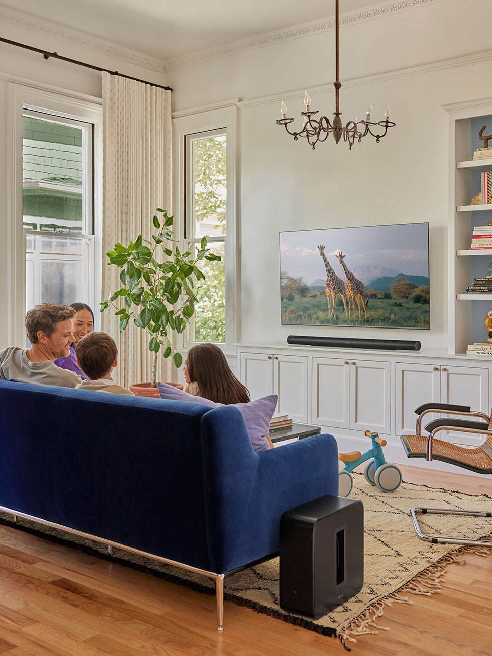 Family Listening to SONOS Subwoofer in Living Room