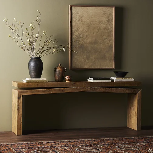 Wooden console table with a vase on top, serving as an elegant end table in a stylish interior setting.