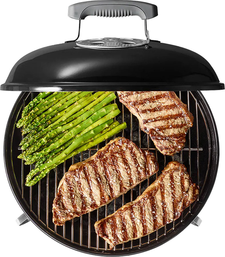 Steak and Asperagus Grilling Inside a Weber Charcoal Smoker and Grill
