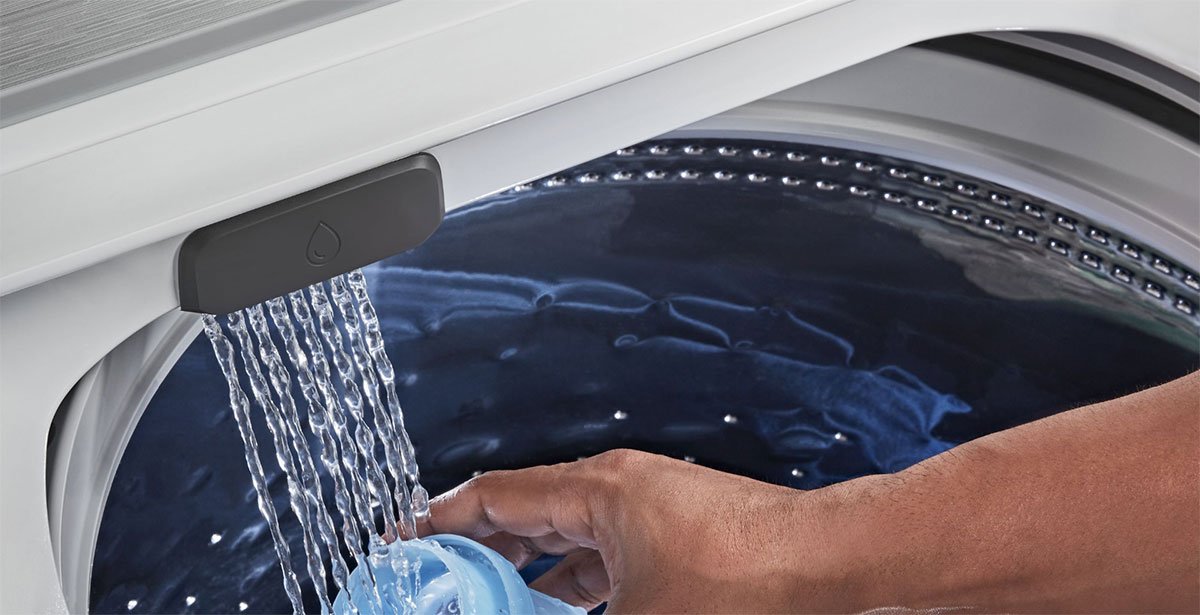 The water faucet being used to fill a cap.