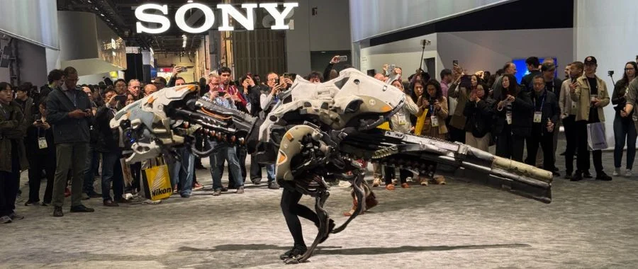 Sony robot dinosaur in front of a crowd of people