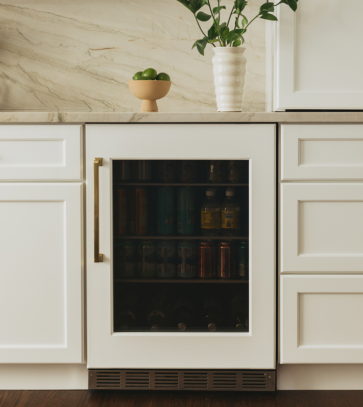 Modern kitchen with a Thermador built-in wine refrigerator and a stylish island, highlighting elegant design and functional luxury