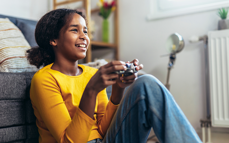 a happy kid enjoying playing video games