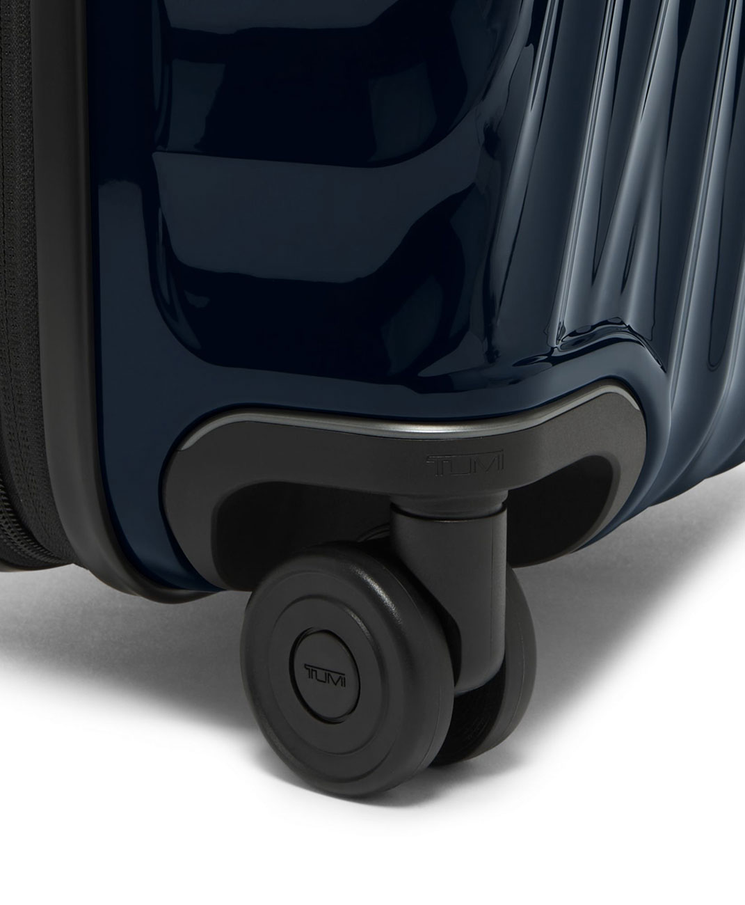 Close Up View of the TUMI 19 Degree Navy International Expandable 4 Wheeled Carry-On Wheel