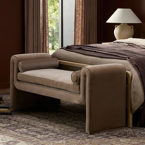 A serene bedroom scene with a bed and a matching bench at the foot