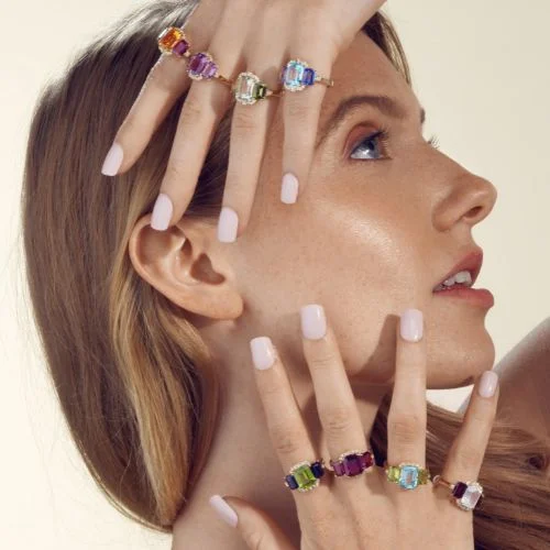 Right shot on a person wearing a stackec Goshwara stacked chain link necklace with a a ring stack on each finger of Goshwara rings