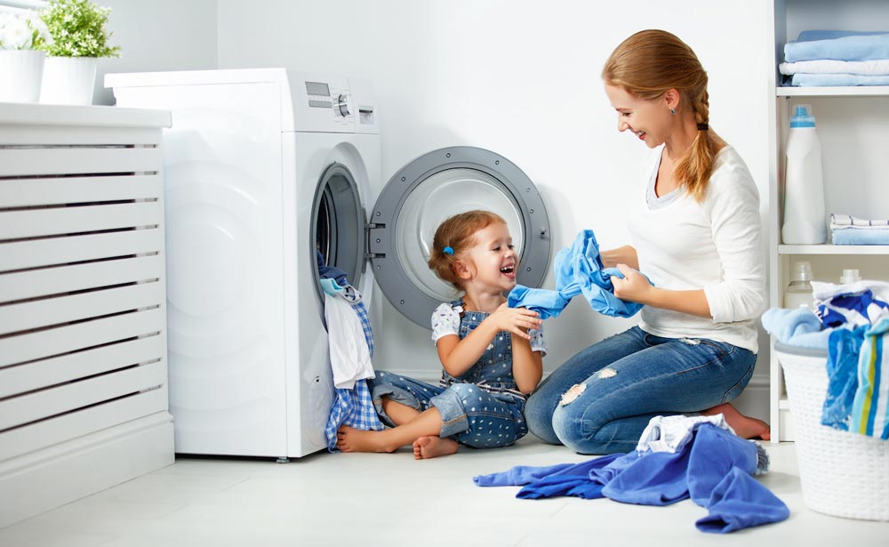 mom and daughter doing laundry