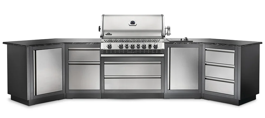 A silver color built-in grill, installed with a full outdoor kitchen set.