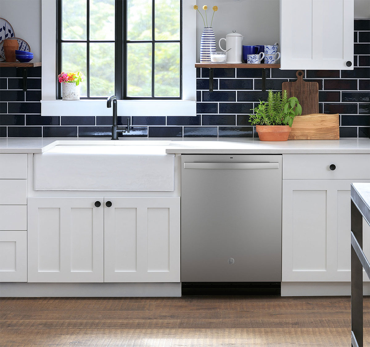 Stainless Steel GE Dishwasher in a Blue and White Kitchen