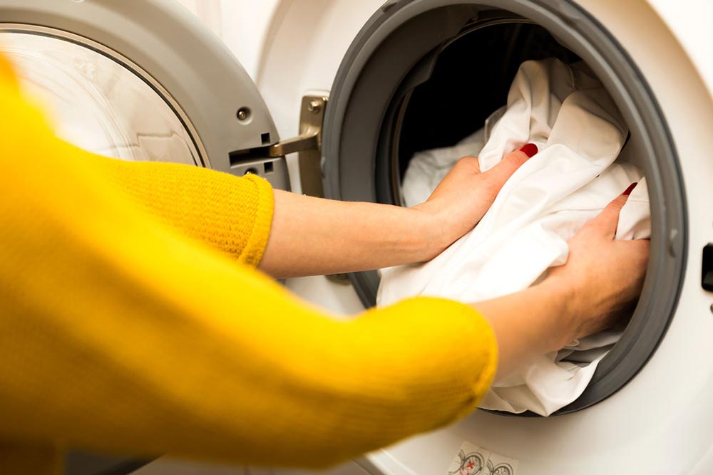 Woman Hand Loading Dirty Clothes