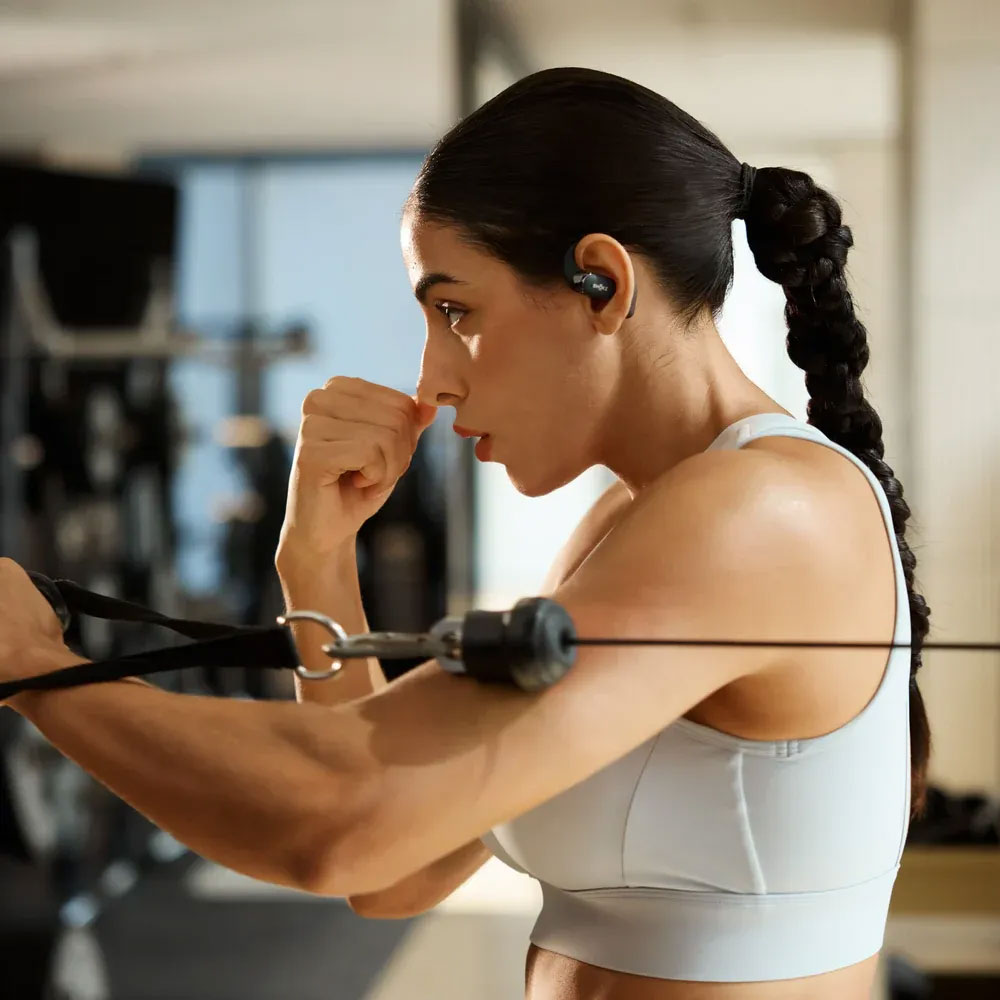 View of Model Boxing While Wearing Shokz Earbuds