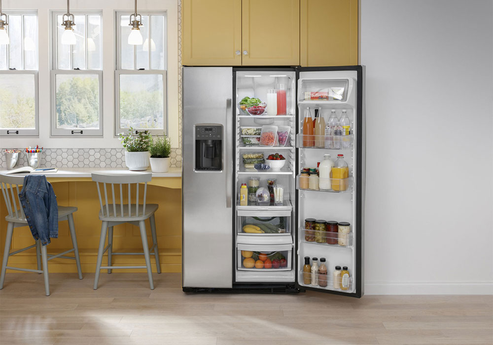 Front view of fridge installed in yellow kitchen, right door open