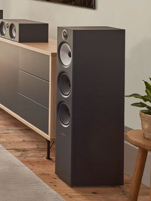 Home theater bookshelf speakers flanking a large flat‑screen TV in a contemporary living room