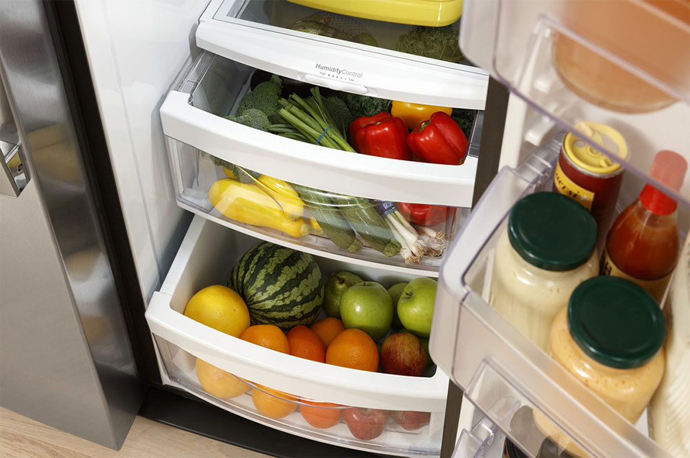 Angled view of crisper bins inside of refrigerator