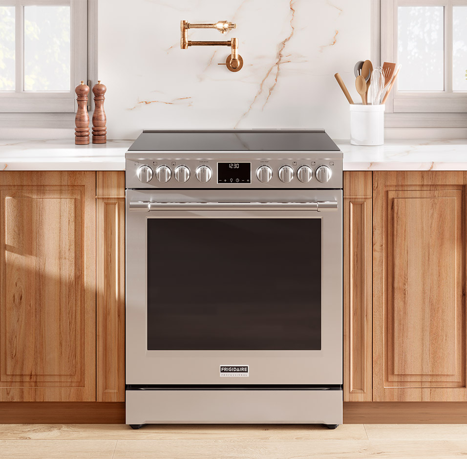 elegant kitchen with light wooden cabintry highlighting the stainless steel frigidaire professional range