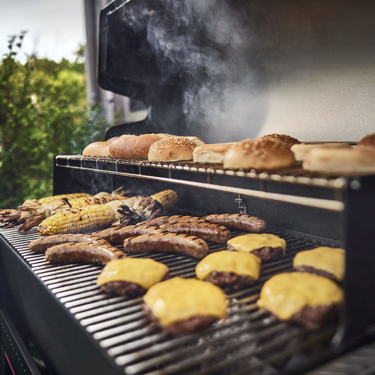 Lifestyle View of Weber Searwood XL 600 Pellet Grill Cooking Food